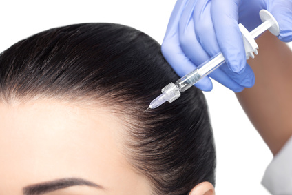 Procedure of mesotherapy. The doctor cosmetologist makes the procedure of mesotherapy in woman's head. Strengthen hair and their growth.