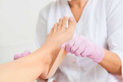 Patient on medical pedicure procedure visiting podiatrist.Podologic polymer gel plates.Protecting the skin ulceration.Bedsore prevention.Foot treatment in SPA salon.Podiatry clinic.